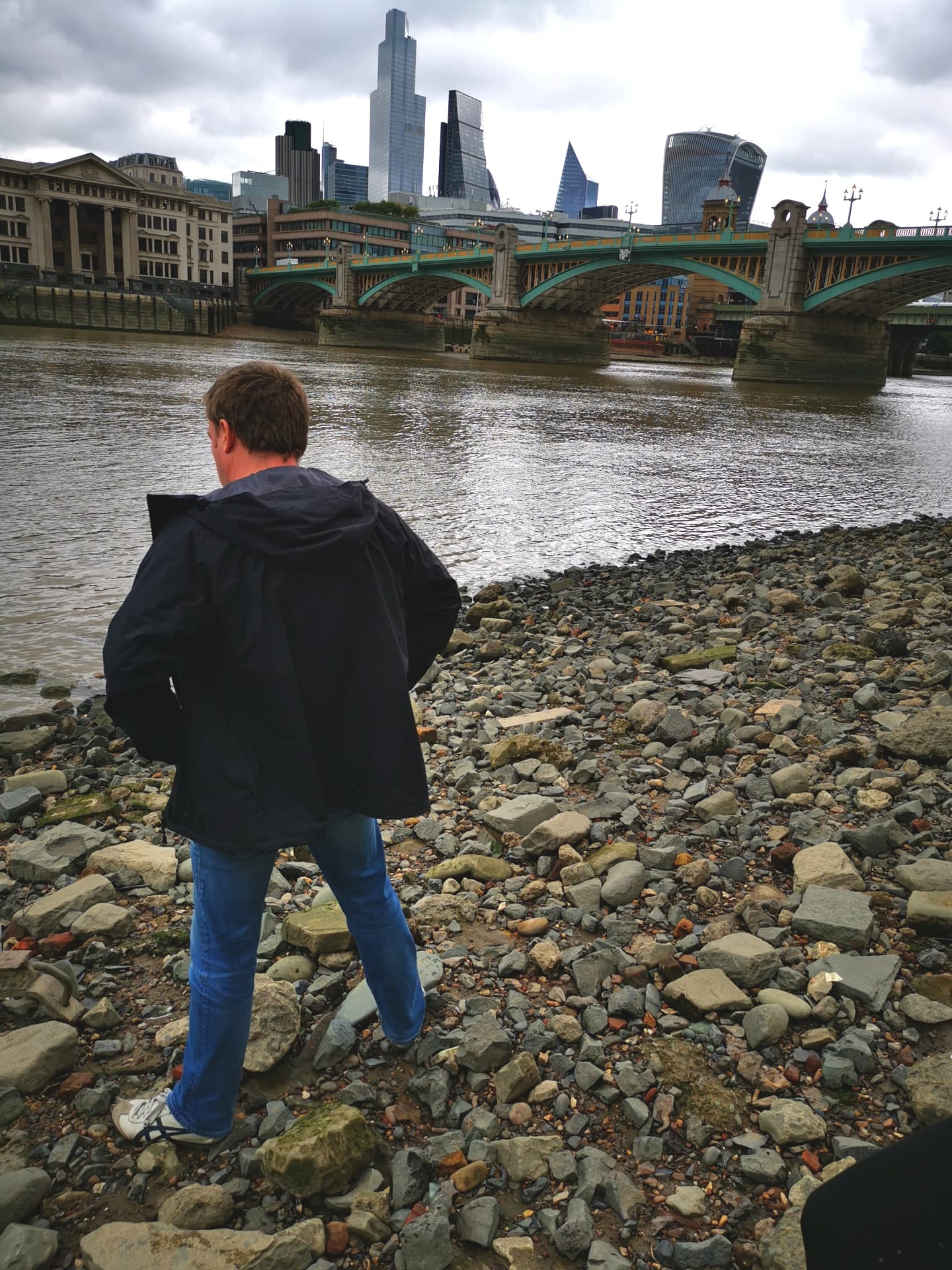London skyline and Southwark Bridge seen from the River Thames foreshore
